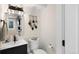 Compact bathroom with a modern vanity, decorative mirror, and neutral color scheme at 613 N Brentwood Ct, Castle Rock, CO 80104