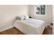 This bedroom features a cozy queen-sized bed with white bedding and a bright window at 613 N Brentwood Ct, Castle Rock, CO 80104