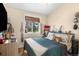 This bedroom features a comfy bed with an assortment of pillows, natural light, and wood floors at 613 N Brentwood Ct, Castle Rock, CO 80104