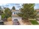 Charming two-story home featuring a well-manicured lawn, mature trees, and a two-car garage in a quiet neighborhood at 613 N Brentwood Ct, Castle Rock, CO 80104