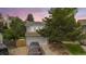 Charming two-story home featuring a well-manicured lawn, mature trees, and a two-car garage in a quiet neighborhood at 613 N Brentwood Ct, Castle Rock, CO 80104
