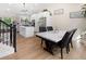 Bright, updated kitchen with island, dining table, stainless appliances and sleek white cabinets at 613 N Brentwood Ct, Castle Rock, CO 80104
