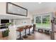 Open-concept kitchen featuring a breakfast bar with seating, a large mirror, and a window with backyard views at 613 N Brentwood Ct, Castle Rock, CO 80104