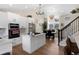 Bright kitchen with white cabinets, stainless appliances, an island, and a dining area with large windows at 613 N Brentwood Ct, Castle Rock, CO 80104