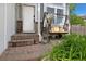 Inviting front porch with a charming swing, brick accents, and well-maintained landscaping creates a warm welcome at 613 N Brentwood Ct, Castle Rock, CO 80104