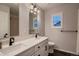 Bright bathroom with double vanity, dark wood floors, and modern lighting at 6358 S Miller Way, Littleton, CO 80127