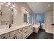 Luxurious bathroom featuring double sinks, modern fixtures, soaking tub, and walk-in shower with marble tile at 6358 S Miller Way, Littleton, CO 80127