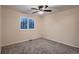 Inviting bedroom with ceiling fan, neutral carpet, and a large window with shuttered blinds at 6358 S Miller Way, Littleton, CO 80127
