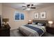 Warm and inviting bedroom featuring a bed, shuttered windows, and stylish decor at 6358 S Miller Way, Littleton, CO 80127