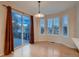 Dining area with sliding door access to the backyard deck and large windows with plantation shutters at 6358 S Miller Way, Littleton, CO 80127