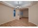 Dining room with hardwood floors, decorative chandelier, and natural light streaming through the window at 6358 S Miller Way, Littleton, CO 80127