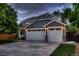 Charming two-story home with a gray exterior, a two-car garage, and a well-manicured lawn at 6358 S Miller Way, Littleton, CO 80127