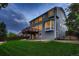 Back of home featuring a spacious yard, patio, deck, and spiral staircase at 6358 S Miller Way, Littleton, CO 80127