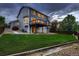 Back of home featuring a spacious yard, patio, deck, and spiral staircase at 6358 S Miller Way, Littleton, CO 80127