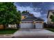 Two-story home featuring a gray exterior, two-car garage, covered porch, and well-kept landscaping at 6358 S Miller Way, Littleton, CO 80127