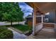 Cozy front porch with white railings and hanging flower baskets at 6358 S Miller Way, Littleton, CO 80127