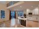 Open concept kitchen with white cabinets, stainless steel appliances, and a large island with sink at 6358 S Miller Way, Littleton, CO 80127