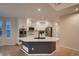 Modern kitchen featuring white cabinetry, stainless steel appliances, and a spacious center island at 6358 S Miller Way, Littleton, CO 80127