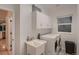 Bright laundry room with washer, dryer, utility sink, and white cabinets at 6358 S Miller Way, Littleton, CO 80127