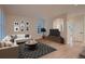 Bright living room with wood floors, sofa, area rug, and natural light at 6358 S Miller Way, Littleton, CO 80127