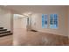 Open-concept living area featuring hardwood floors, large windows, and access to the dining area at 6358 S Miller Way, Littleton, CO 80127