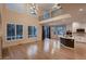 Open-concept living room with high ceilings, large windows, and a modern kitchen area at 6358 S Miller Way, Littleton, CO 80127