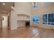 Bright living room features a cozy fireplace and large windows offering plenty of natural light at 6358 S Miller Way, Littleton, CO 80127