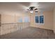 Cozy loft area with neutral carpet, ample natural light, and a ceiling fan, creating a relaxing ambiance at 6358 S Miller Way, Littleton, CO 80127