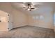 Large bedroom offers a vaulted ceiling, carpet flooring, and three windows with plantation shutters at 6358 S Miller Way, Littleton, CO 80127