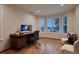Office space with wood floors, desk, and large window at 6358 S Miller Way, Littleton, CO 80127