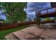 Stamped concrete patio and well-maintained lawn leading to a deck with spiral staircase at 6358 S Miller Way, Littleton, CO 80127