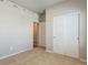 Carpeted bedroom with neutral paint, two closets with sliding doors, and two doorways at 48265 Shetland Dr, Bennett, CO 80102