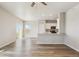 Bright, open-concept living space featuring wood-look floors, light walls, and a modern kitchen with stainless appliances at 48265 Shetland Dr, Bennett, CO 80102
