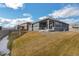 Spacious backyard with a patio and grassy area at 1680 Rivergate Way, Berthoud, CO 80513