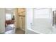 Bathroom with a shower/tub combo, tile flooring, and a window at 1680 Rivergate Way, Berthoud, CO 80513