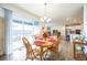 Dining area with wooden table and view into living room and kitchen at 1680 Rivergate Way, Berthoud, CO 80513