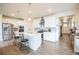 Modern kitchen with white cabinets, island, and stainless steel appliances at 1680 Rivergate Way, Berthoud, CO 80513