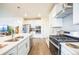 Open concept kitchen with island and stainless steel appliances at 1680 Rivergate Way, Berthoud, CO 80513