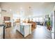 Modern kitchen with white cabinets, stainless steel appliances and island at 1680 Rivergate Way, Berthoud, CO 80513
