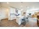 Open kitchen with island, stainless steel appliances, and view of dining area at 1680 Rivergate Way, Berthoud, CO 80513