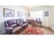 Home office with leather couch, wooden desk, and window at 1680 Rivergate Way, Berthoud, CO 80513