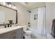 Modern bathroom with a gray vanity, a black framed mirror, and a shower-tub combination at 100 Park W Ave # 201, Denver, CO 80205