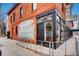 Charming corner building featuring a vintage-style mural and large windows reflecting the interior at 100 Park W Ave # 201, Denver, CO 80205