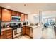 Well-lit kitchen featuring stainless steel appliances and granite countertops open to the living area at 100 Park W Ave # 201, Denver, CO 80205
