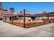 Trendy restaurant exterior with a spacious patio area, vintage van, and artistic decor at 100 Park W Ave # 201, Denver, CO 80205