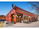 Vibrant restaurant exterior with large windows displaying produce, tables, and a classic red brick facade at 100 Park W Ave # 201, Denver, CO 80205