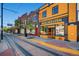 Street view showcasing colorful storefronts, sidewalk details, and vintage-style signage at 100 Park W Ave # 201, Denver, CO 80205