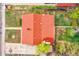 Aerial view of a home with a red roof, green backyard, and a paved driveway at 6990 Larsh Dr, Denver, CO 80221