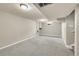 Open basement space with carpet floors; ready for customization at 6990 Larsh Dr, Denver, CO 80221