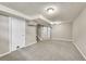 Finished basement with neutral carpet and paint, ready to be customized into a living area at 6990 Larsh Dr, Denver, CO 80221